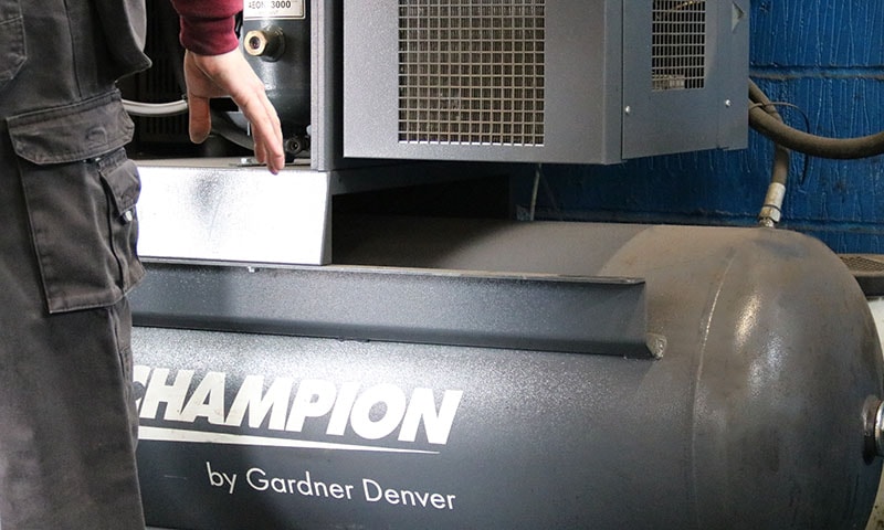 Technician selecting the right air compressor for a workshop