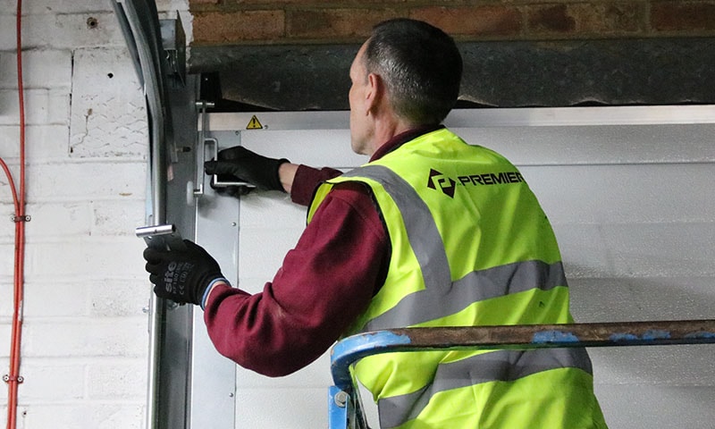 Technician carrying out an emergency repair on a faulty industrial door