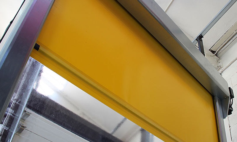 Rapid action door close-up showing yellow curtain and drive mechanism