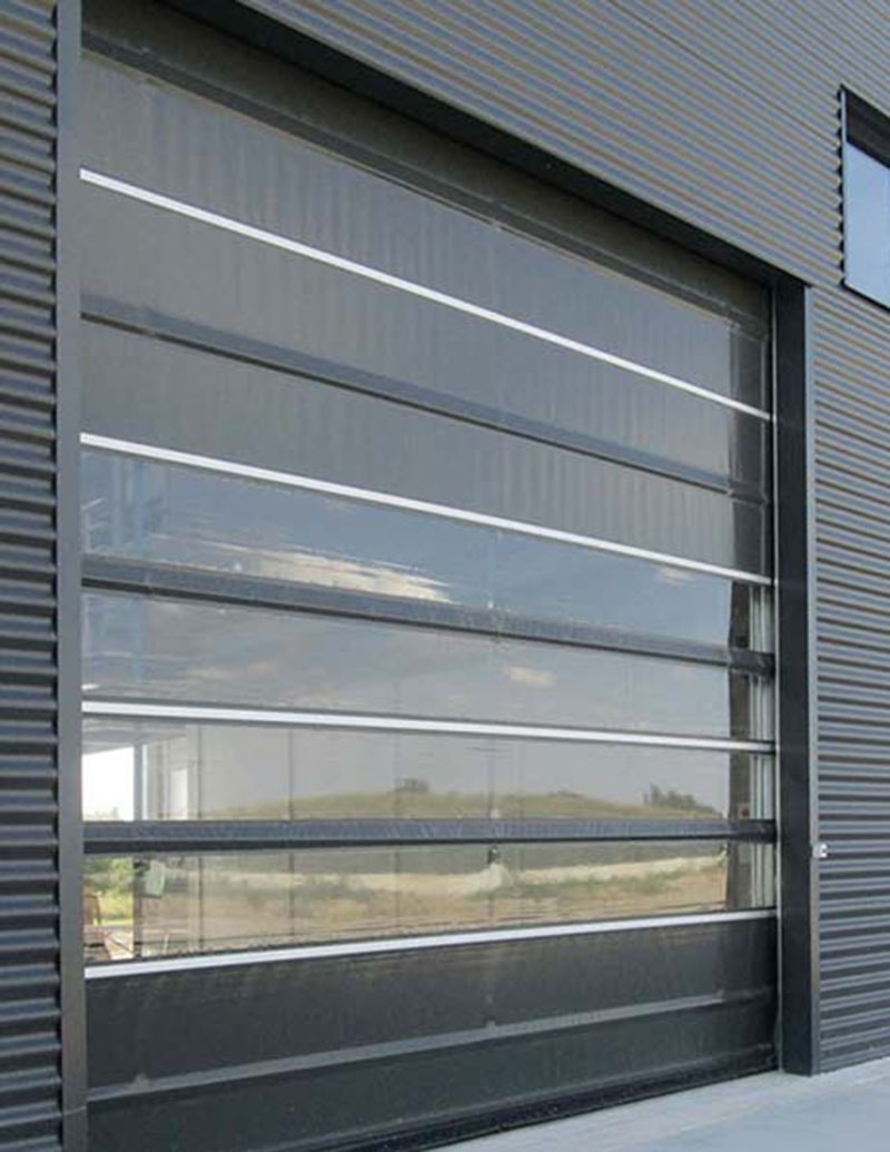 Modern glazed rapid action door with aluminium frame on industrial building