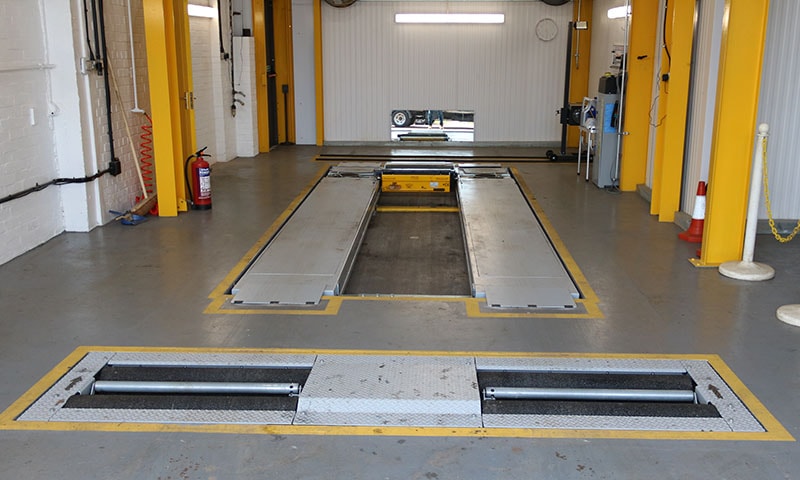 Platform scissor lift in a workshop MOT bay